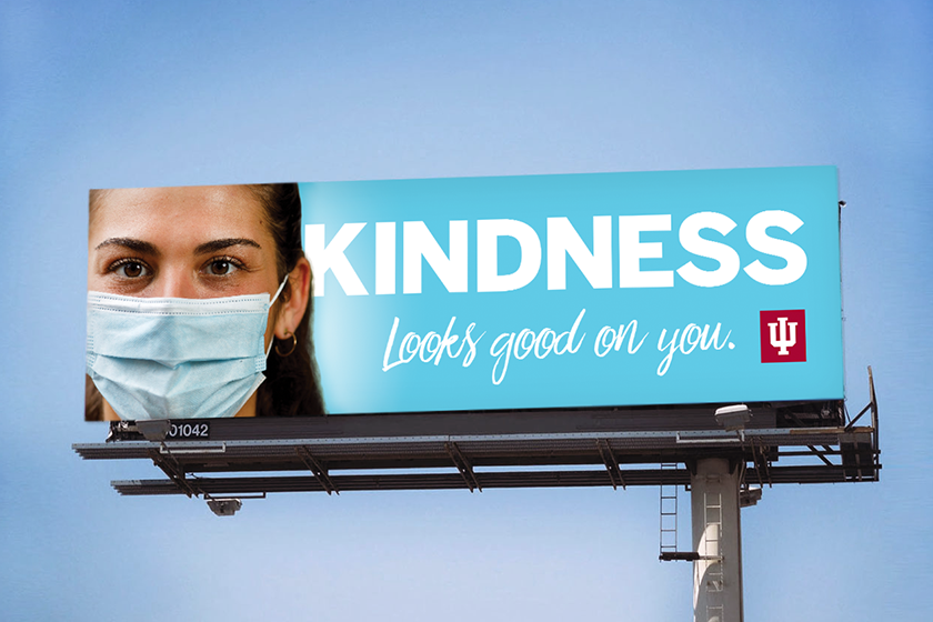 A billboard reads "KINDNESS looks good on you."